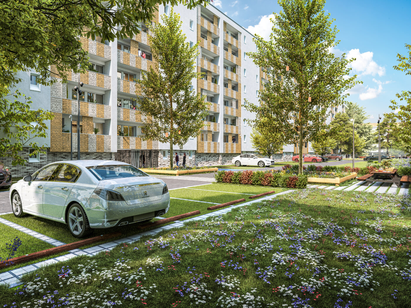Le stationnement résidentialisé à Bagneux : places en dalles engazonnées, prairie fleurie et façades à garde-corps en tôle perforée dorée