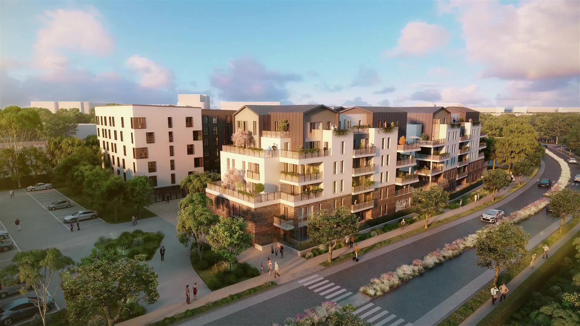Vue aérienne d’une résidence à Villiers-sur-Marne au soleil couchant : toitures en zinc, façades bois et enduit clair, terrasses plantées et voie paysagère